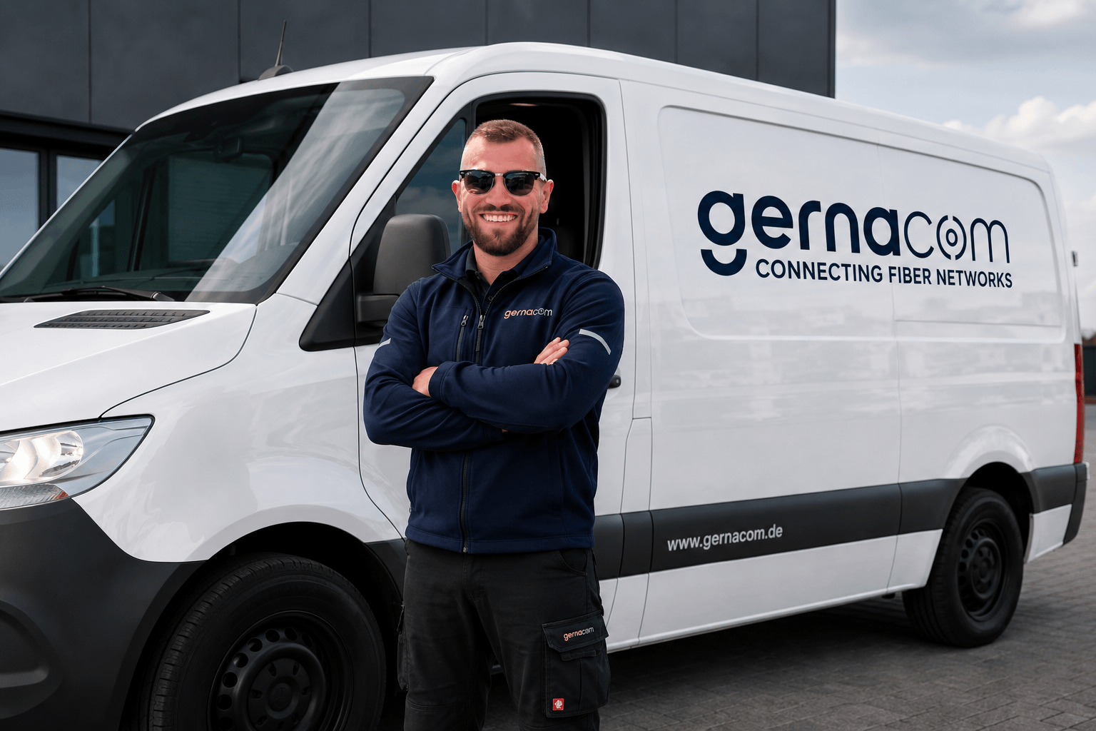 A Gernacom technician standing in front of a branded company van